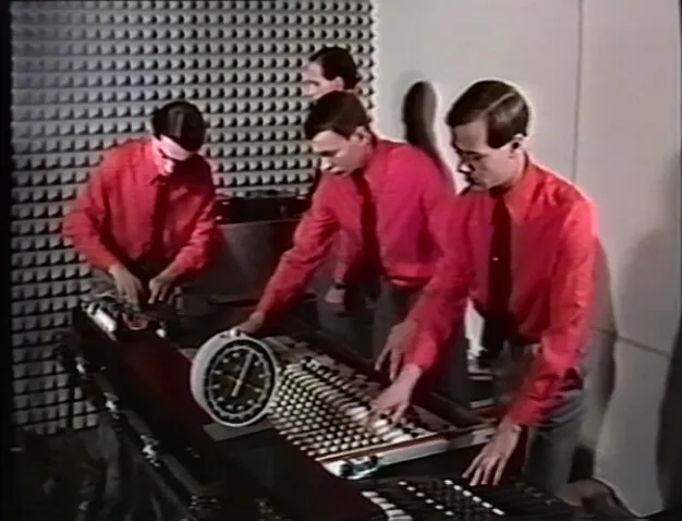 Image of 4 look-alikes making music, they seem to be robots