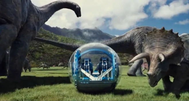 Image from the 2015 film Jurassic World showing a technological bubble surrounded by several large dinosaurs